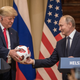 Russian President Vladimir Putin hands U.S. President Donald Trump (L) a World Cup football during a joint press conference after their summit on July 16, 2018 in Helsinki, Finland. The two leaders met one-on-one and discussed a range of issues including the 2016 U.S Election collusion.